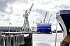 Billedet viser havnen i Nakskov med skibsaktivitet. Forrest til højre ses fronten af et fragtskib, imens man i baggrunden ser et andet skib ved siden af en kran.