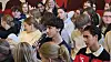 Elev med mikrofon stiller spørgsmål blandt siddende gymnasieelever i aula.
